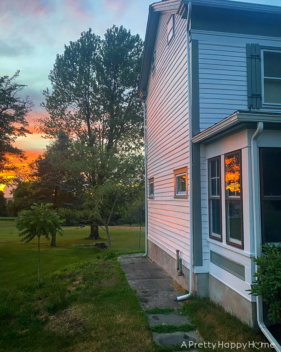 sunset window reflection on colonial farmhouse on the happy list