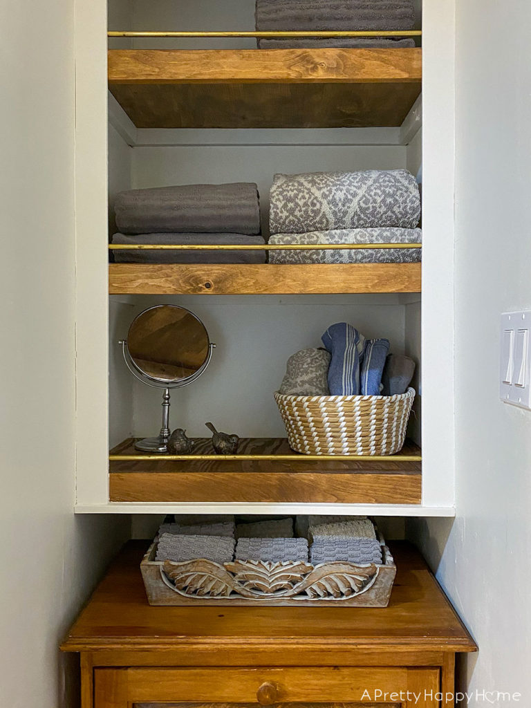 closet shelves with brass rail