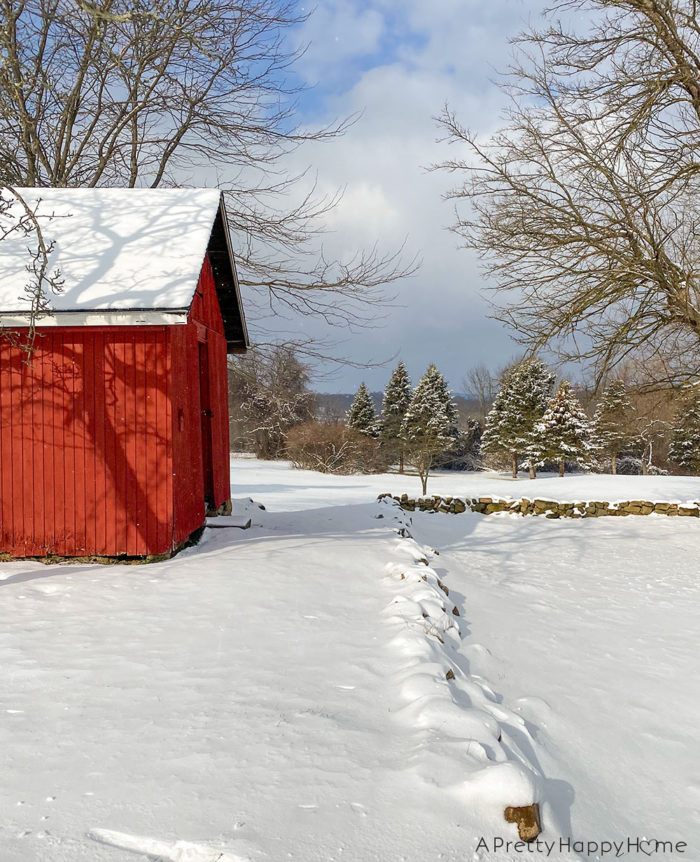 red barn in snow on the happy list