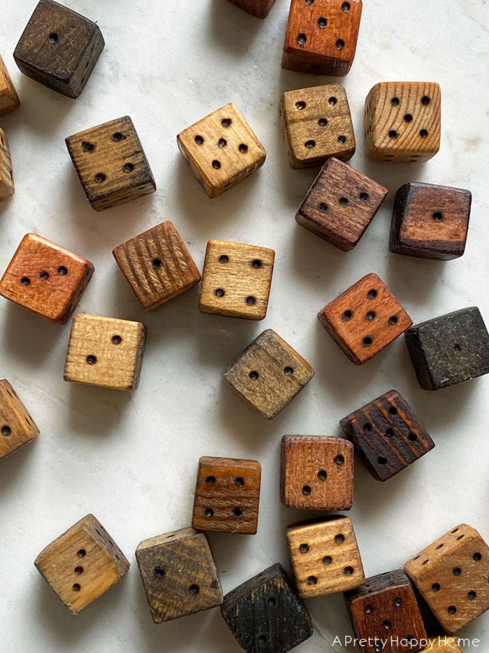 scattering of different colored wood burned dice on a marble table