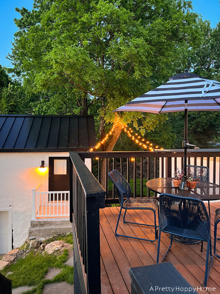 colonial farmhouse deck summer ready with back and white umbrella and blue chairs black white and blue deck decor