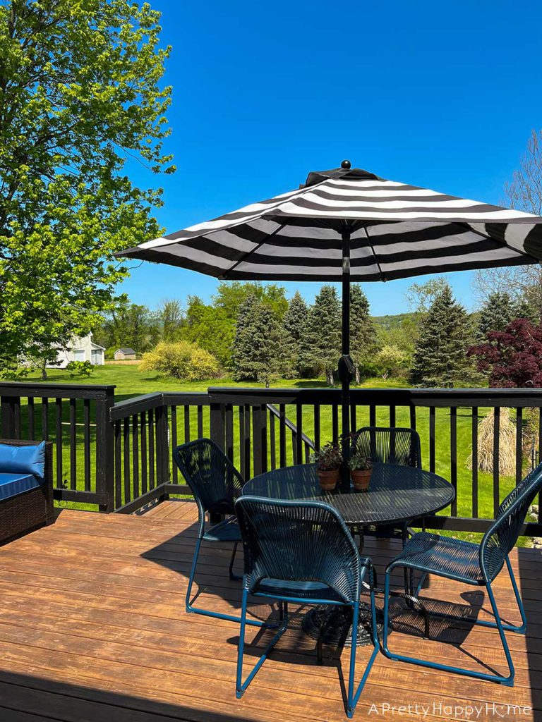 colonial farmhouse deck summer ready with back and white umbrella and blue chairs black white and blue deck decor