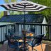 colonial farmhouse deck summer ready with back and white umbrella and blue chairs black white and blue deck decor