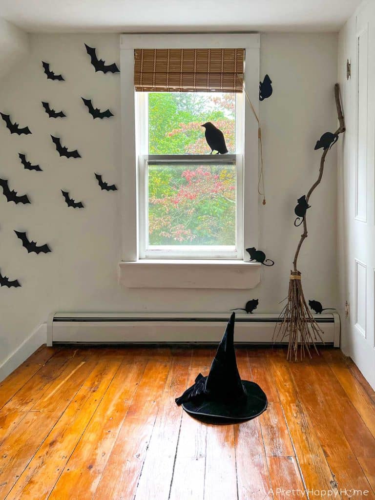 halloween vignette with bats, witch broom, witch hat