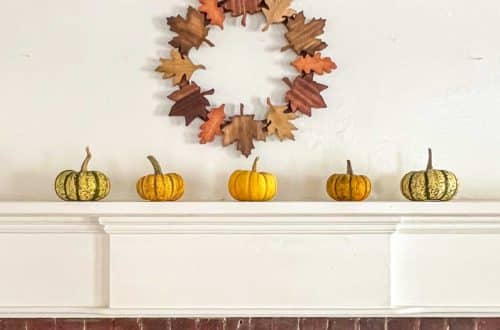 fall mantel with leaf wreath and mini pumpkins on the happy list