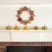 fall mantel with leaf wreath and mini pumpkins on the happy list