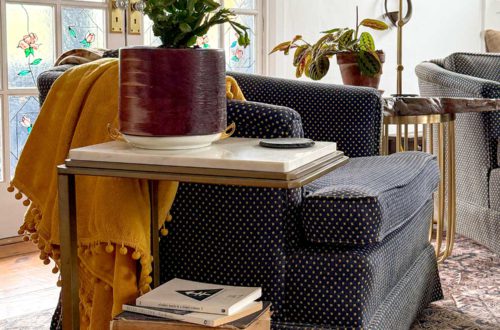 stack of books in a traditional living room with stained glass doors
