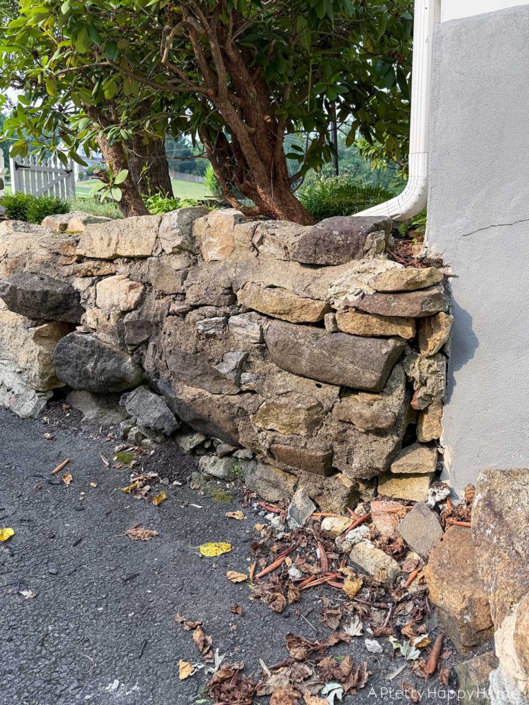 BEFORE DIY low curved fieldstone wall the plan to fix it ourselves with lime mortar