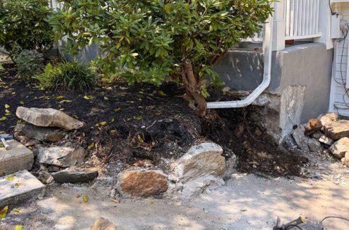 diy curved fieldstone wall demoing the old wall on a colonial era farmhouse