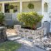 newly rebuilt curved fieldstone wall using lime mortar and natural fieldstone