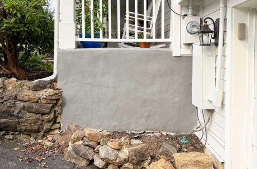 exposing a stone foundation wall and repointing it with lime mortar