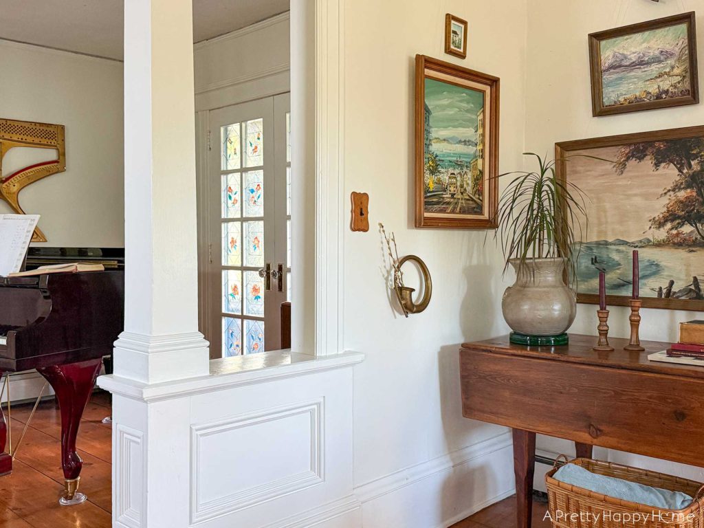 pared down gallery wall gallery wall with a wall pocket wall vase and nature paintings