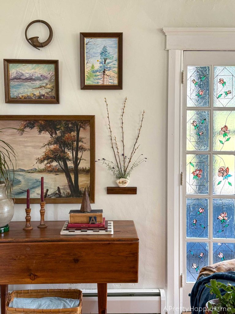 pared down gallery wall gallery wall with a wall pocket wall vase and nature paintings