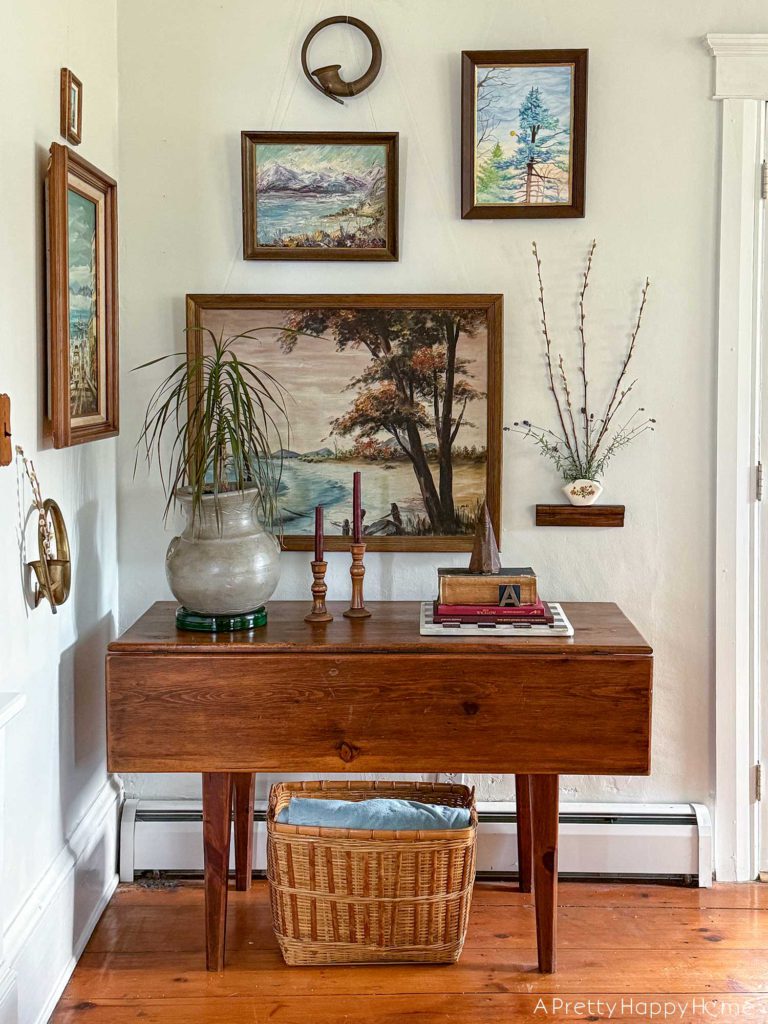 pared down gallery wall gallery wall with a wall pocket wall vase and nature paintings