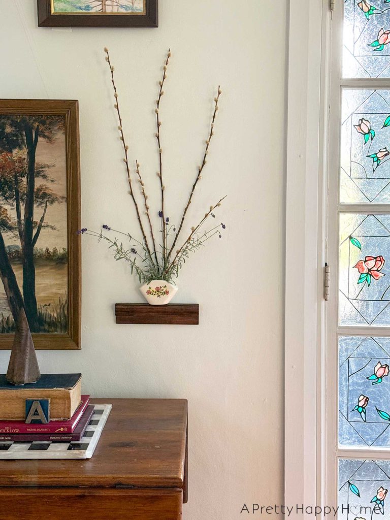 pared down gallery wall gallery wall with a wall pocket wall vase and nature paintings