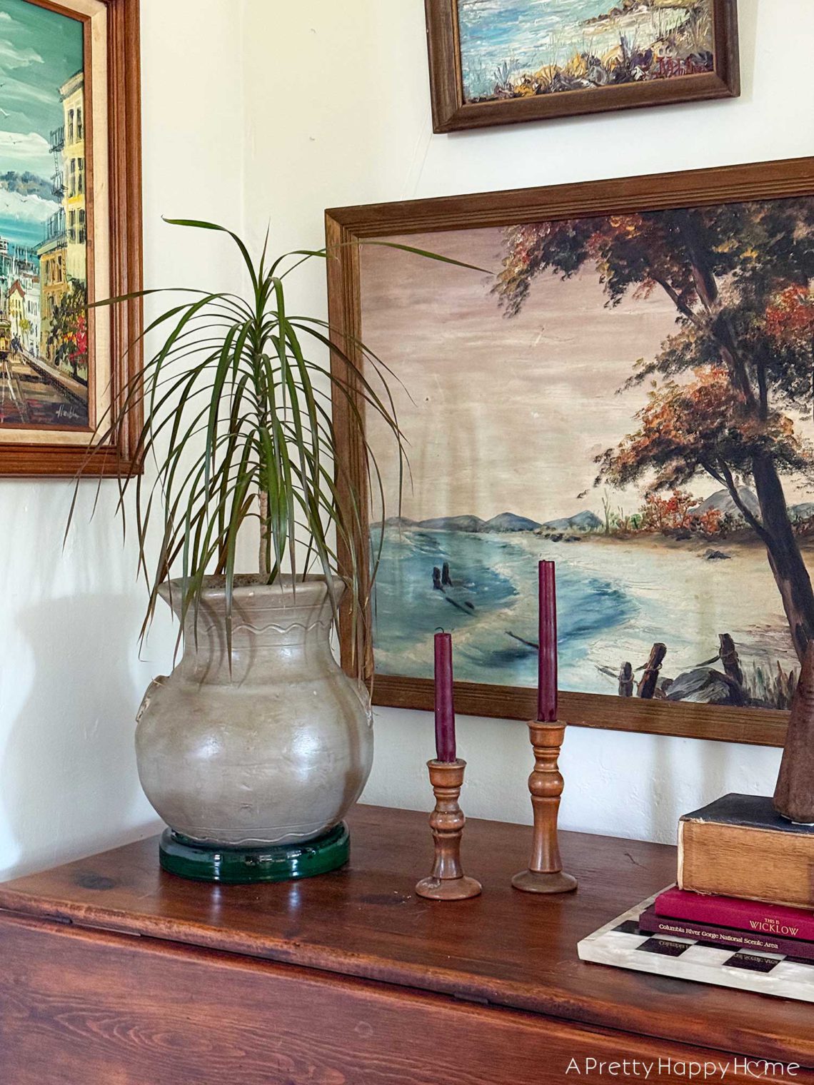 pared down gallery wall gallery wall with a wall pocket wall vase and nature paintings