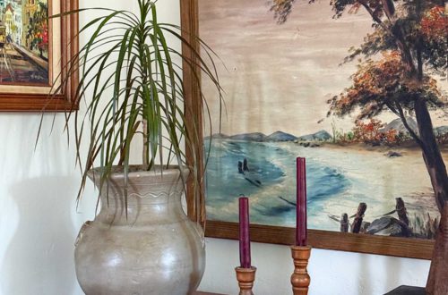 pared down gallery wall gallery wall with a wall pocket wall vase and nature paintings