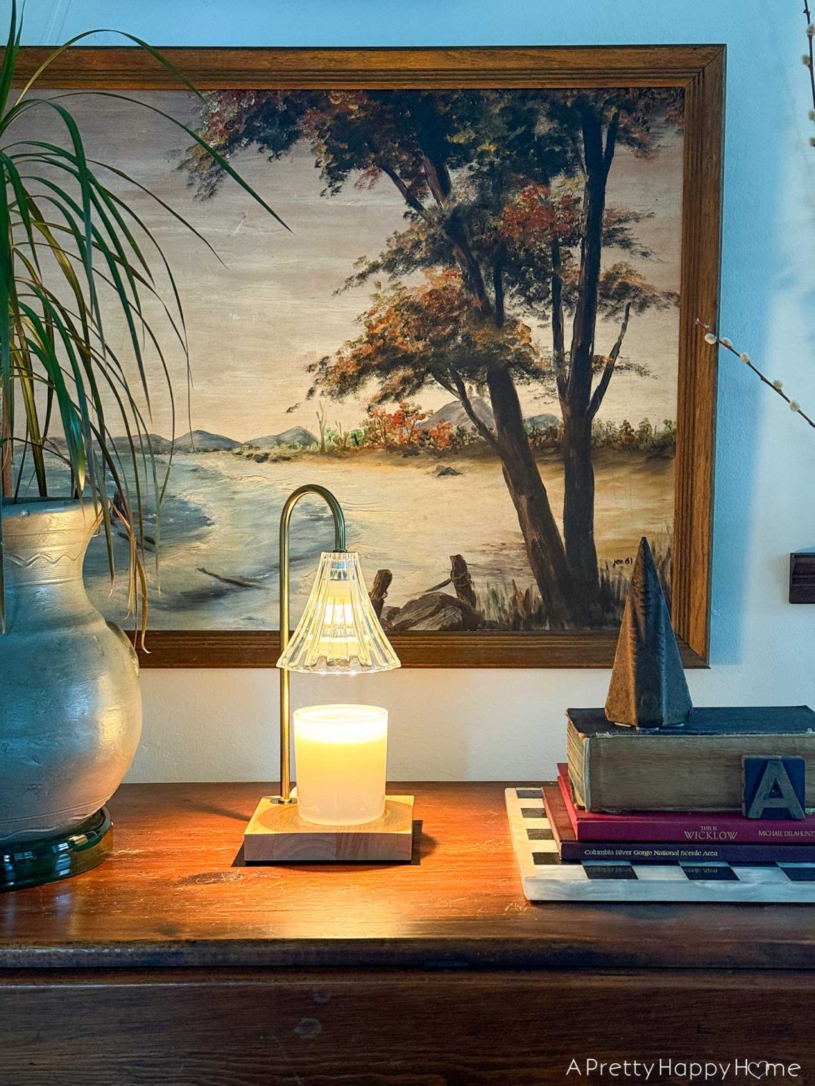candle warmer lamps sitting on a table in front of a gallery wall great christmas gift idea 2025