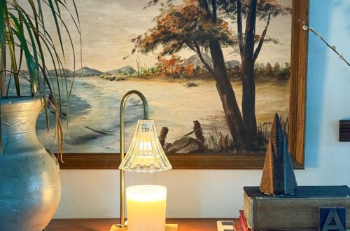candle warmer lamps sitting on a table in front of a gallery wall great christmas gift idea 2025