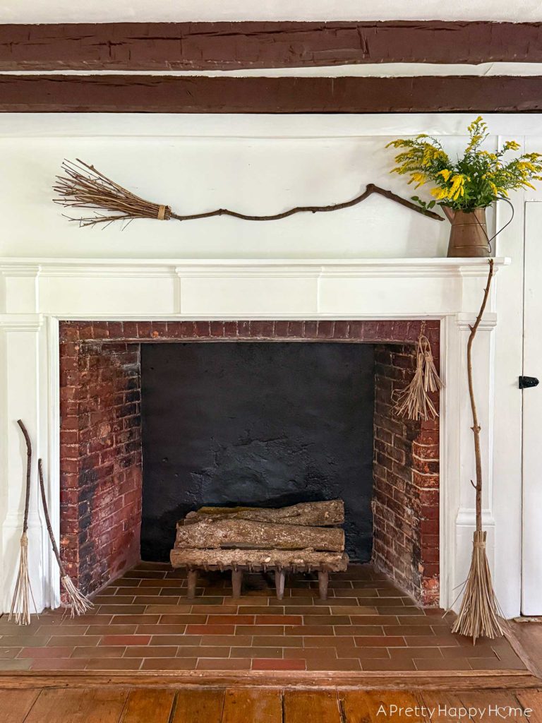 Witchy Halloween Mantel - No Cost Decorating Ideas fireplace decorated with witch's brooms for halloween