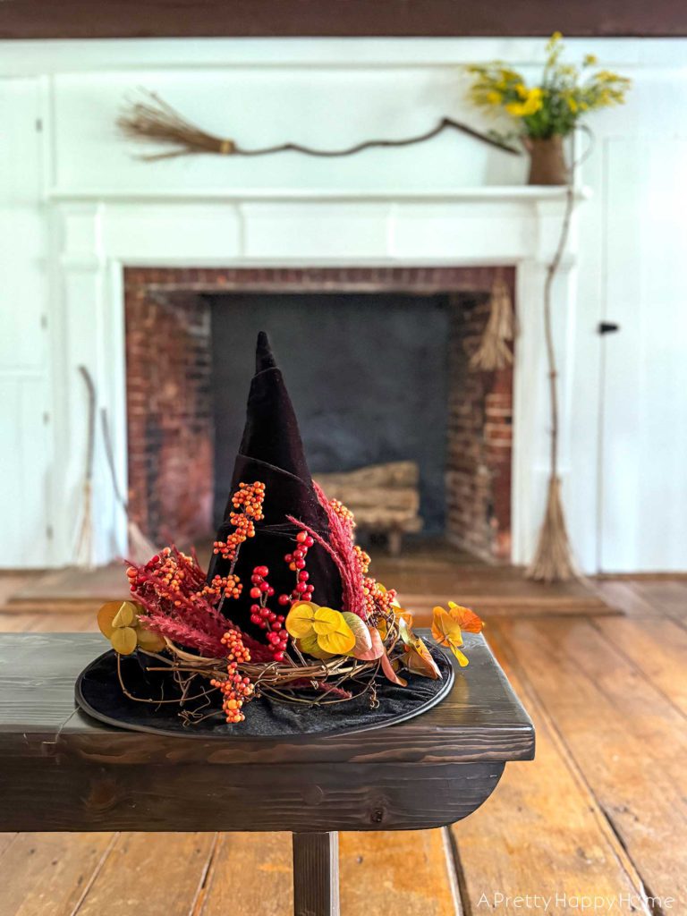 Witchy Halloween Mantel - No Cost Decorating Ideas fireplace decorated with witch's brooms for halloween