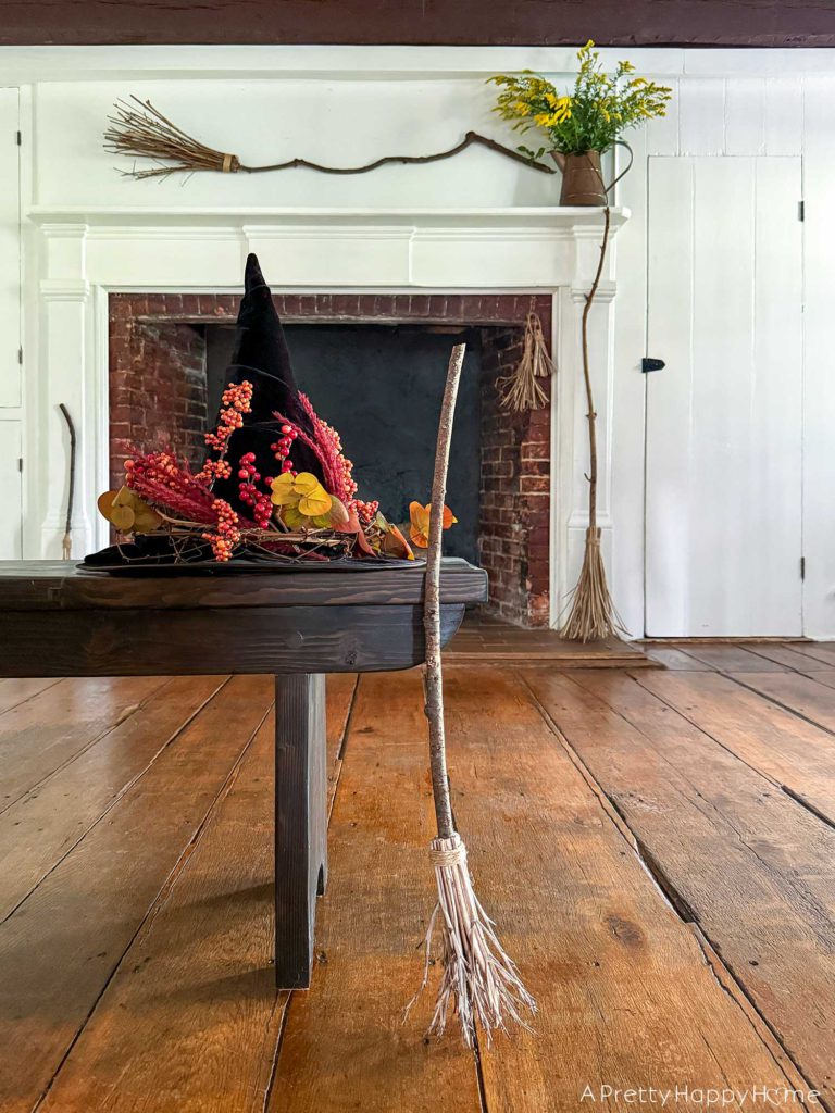 Witchy Halloween Mantel - No Cost Decorating Ideas fireplace decorated with witch's brooms for halloween