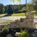 DIY curved fieldstone wall adding a swoop