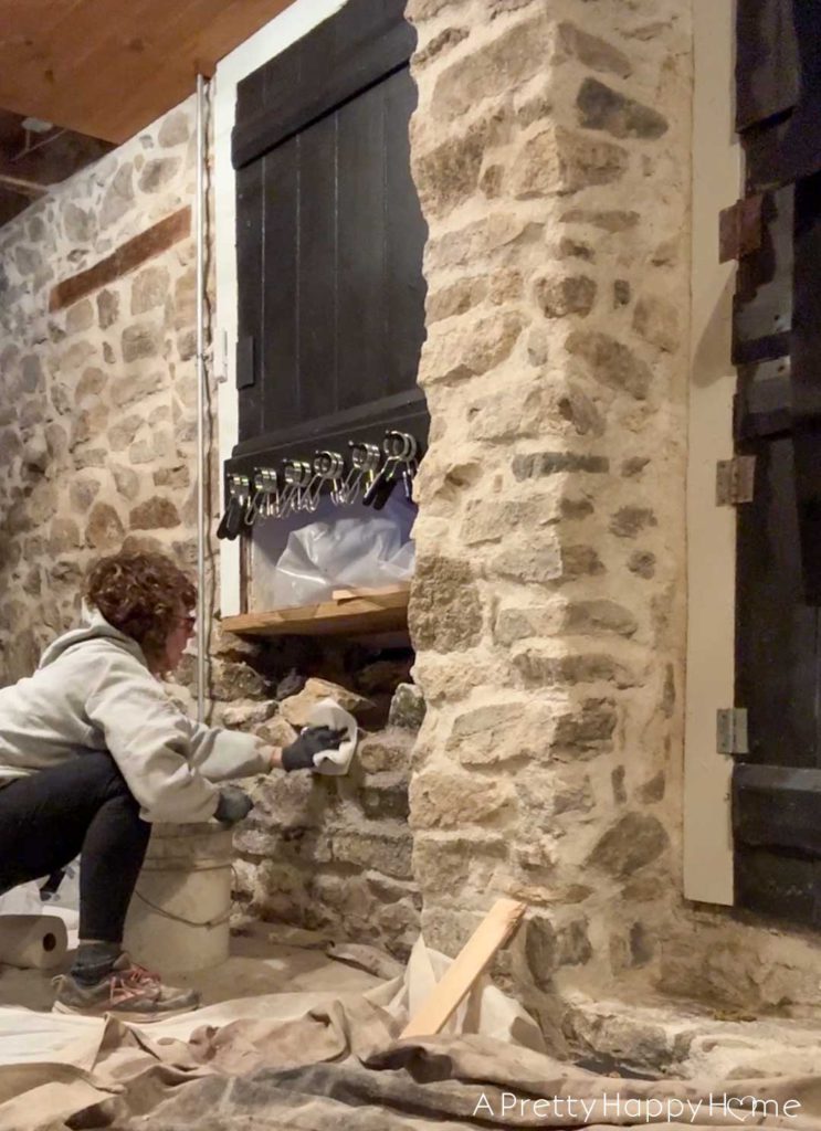 converting a door to a window in a stone building with a stone foundation