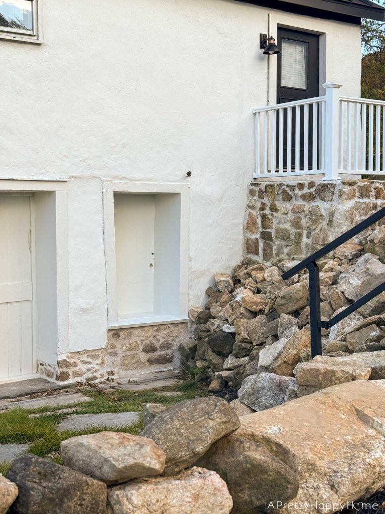 converting a door to a window in a stone building with a stone foundation