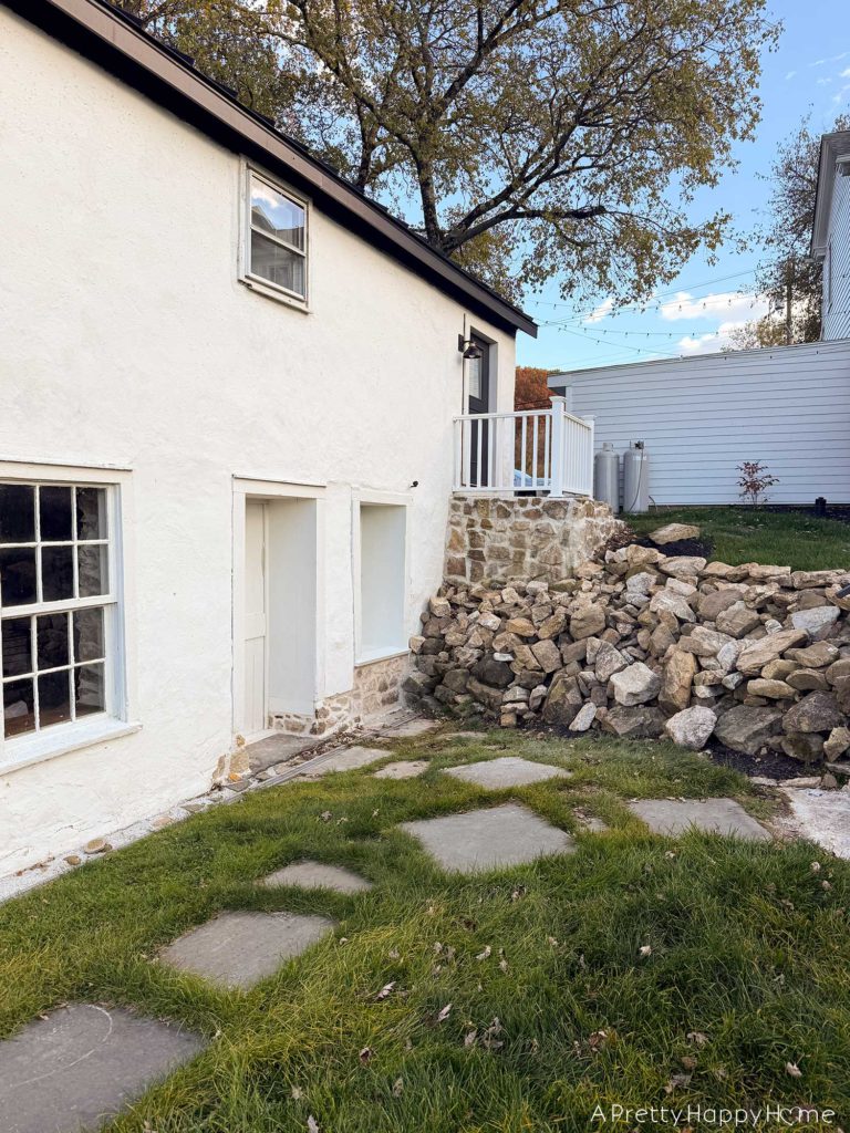 converting a door to a window in a stone building with a stone foundation