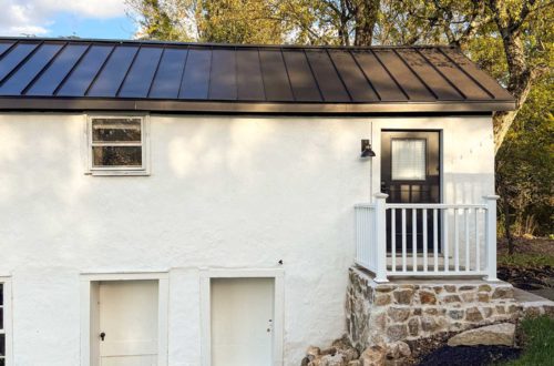 converting a door to a window in a stone building with a stone foundation