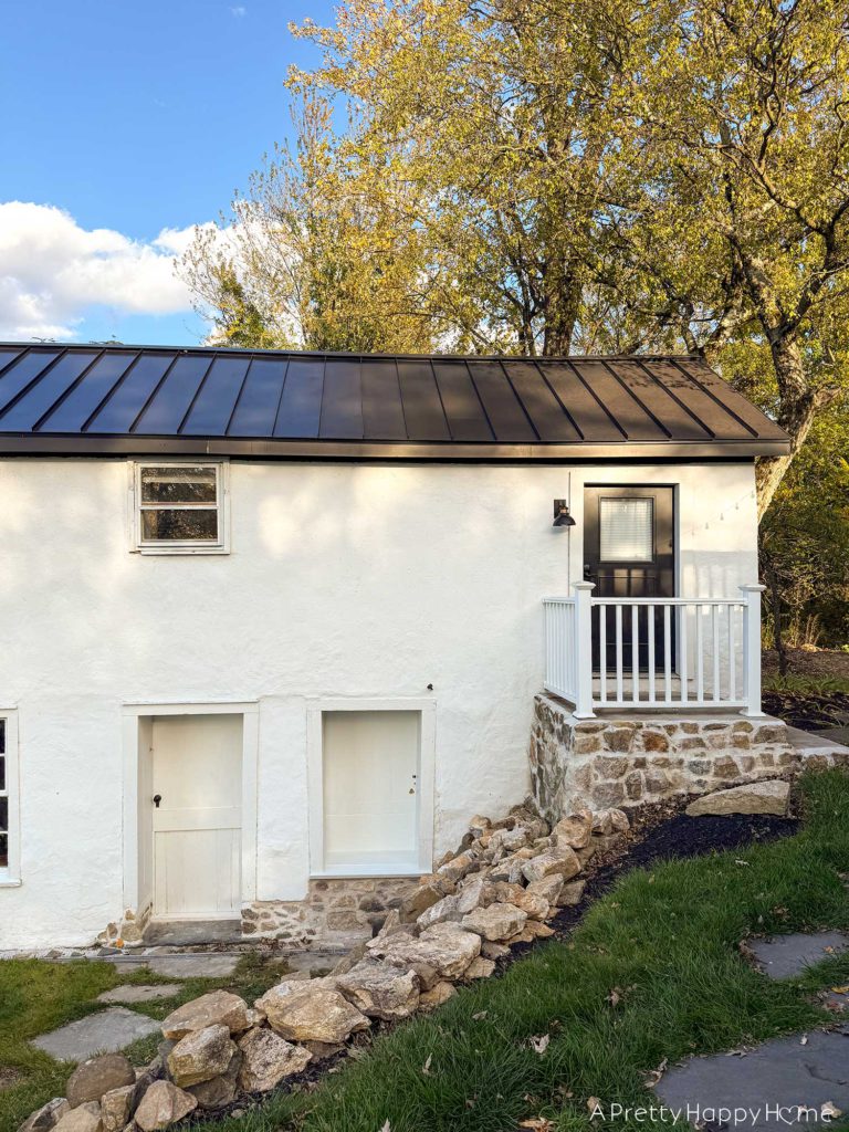 converting a door to a window in a stone building with a stone foundation