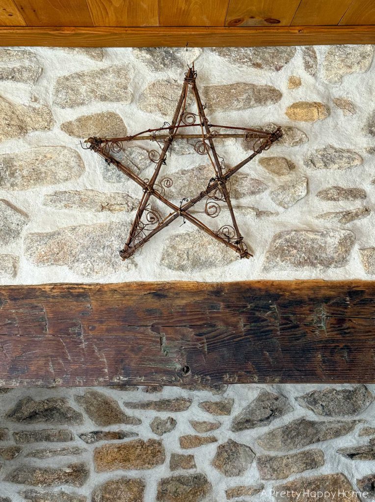 rustic Christmas star made from twigs and vines rustic carriage house christmas rustic stone fireplace decorated for christmas 