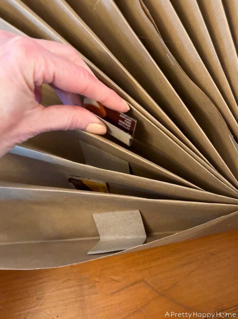 how to make giant paper angel and keep the arms and dress of the folded pleats fanned out by inserting folded over pieces of cardboard in the pleats