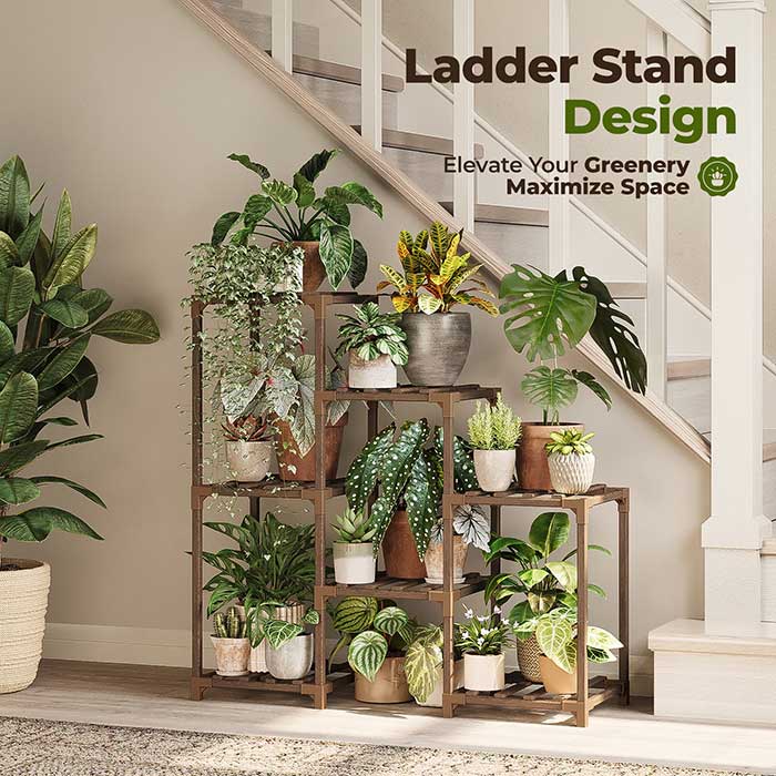 photo of bamworld's ladder plant shelf. It is a tiered style plant shelf with five open cubbies for plants to sit. The shelf is filled with green plants and is sitting in front of top a builder basic beige staircase wall. It's from Walmart and featured in this post on unique plant display ideas.