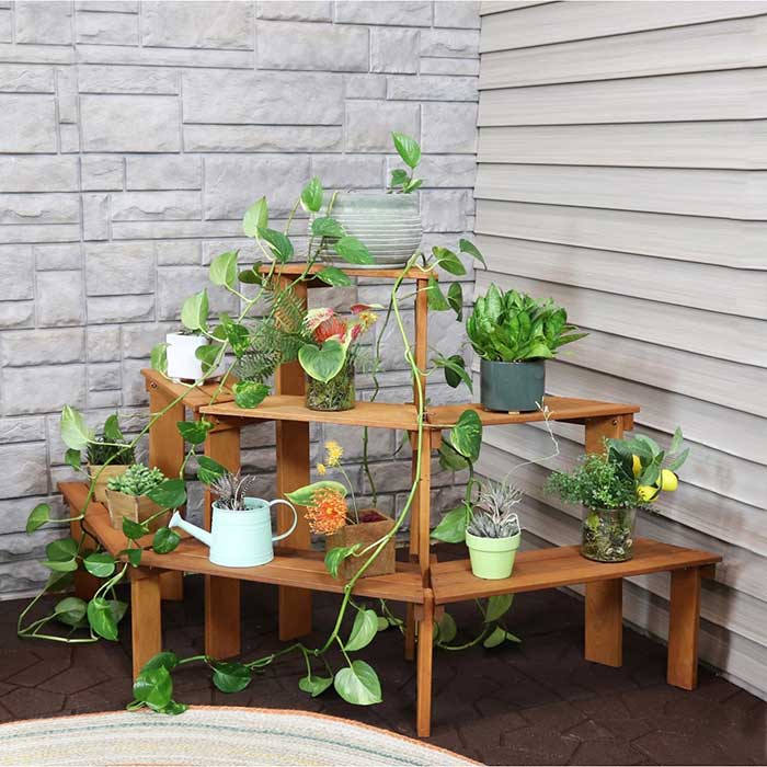3 tier meranti wood plant stand for the outdoors. It is kind of curved in shape, so it doesn't sit flat to the wall. It is filled with plants. It looks better in the reviews than in the advertising pictures. sold by Mayfair. Shown in this blog post on unique plant display ideas.
