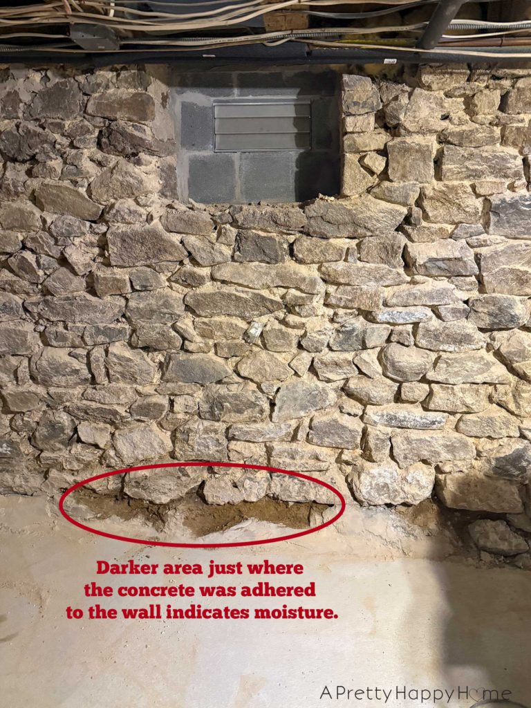 stone foundation from the 1780s chipped out to be repointed with new lime mortar. Photo shows spot at the base of the foundation wall that had been covered in concrete that was trapping moisture in the wall.
