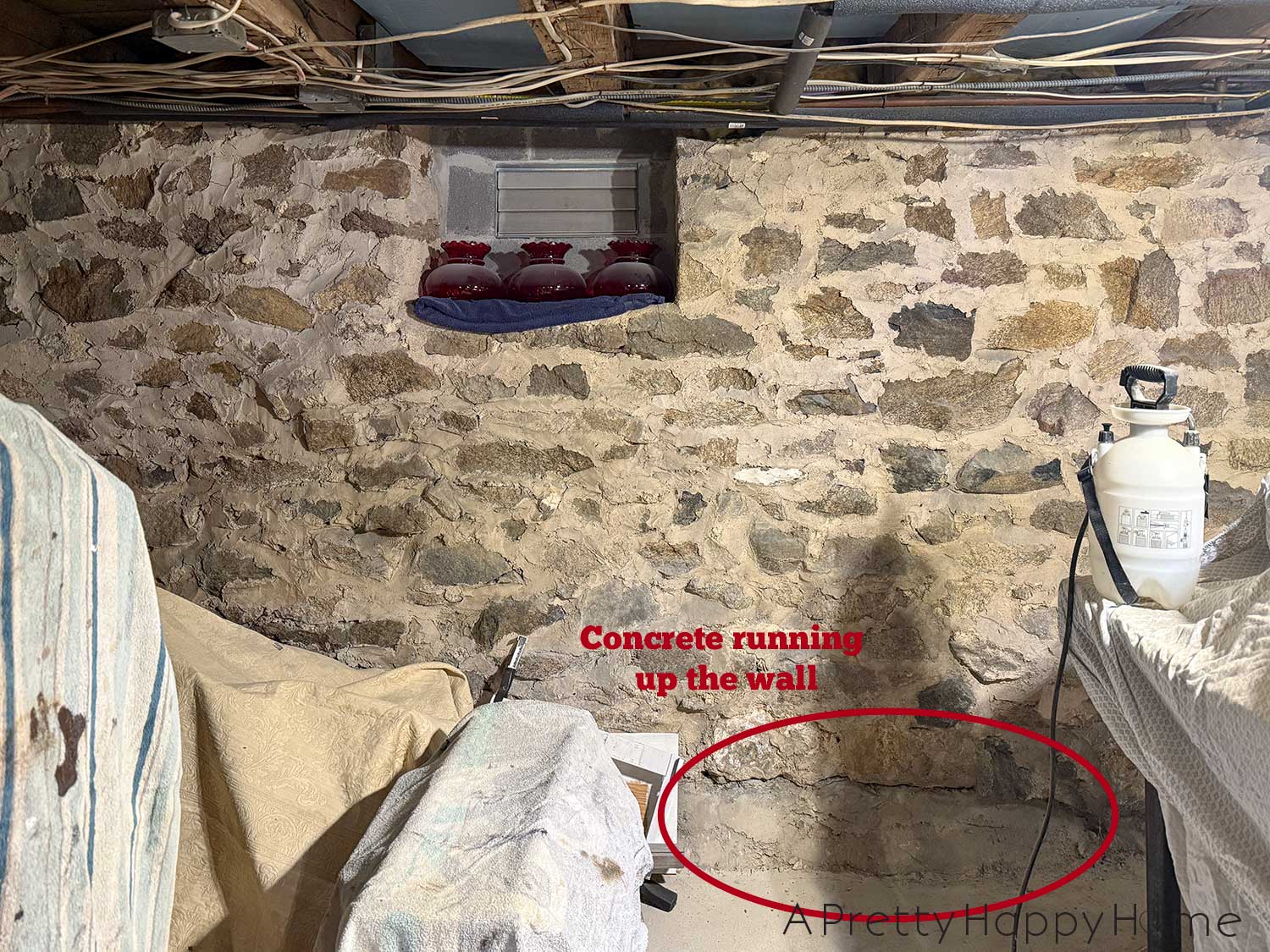Stone foundation walls in a basement of a 1780s home that desperately need to be repointed and repaired after previous patches with concrete