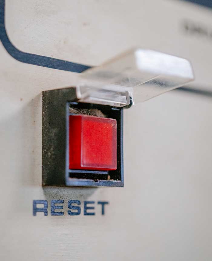 plastic molly guard over a big red button that says reset