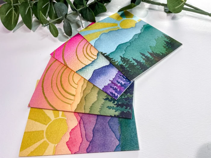 set of four watercolor mountain and sunrise greeting cards by etsy shop pennandlightcreative