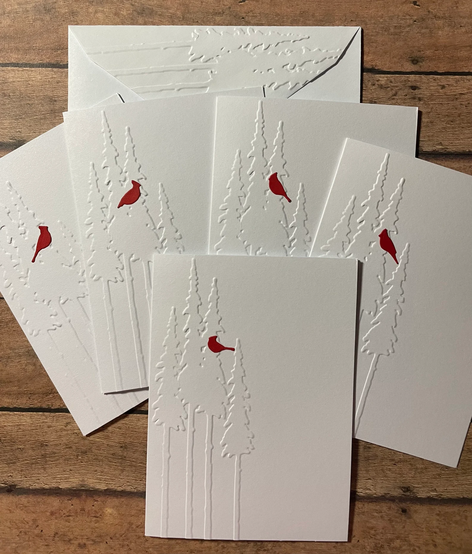embossed greeting cards with the outline of a tree embossed on a white card a red cardinal stands out on the card in contrast by etsy shop paperartflower