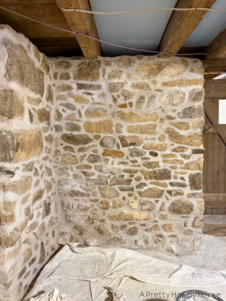 stone foundation wall in a basement recently repointed with lime mortar using natural hydraulic lime