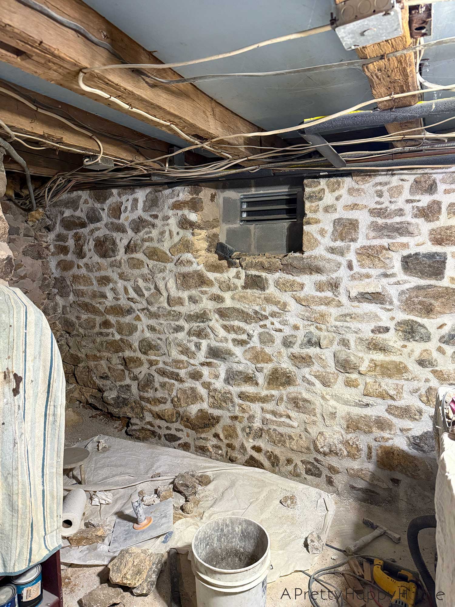 stone foundation wall in a basement recently repointed with lime mortar using natural hydraulic lime