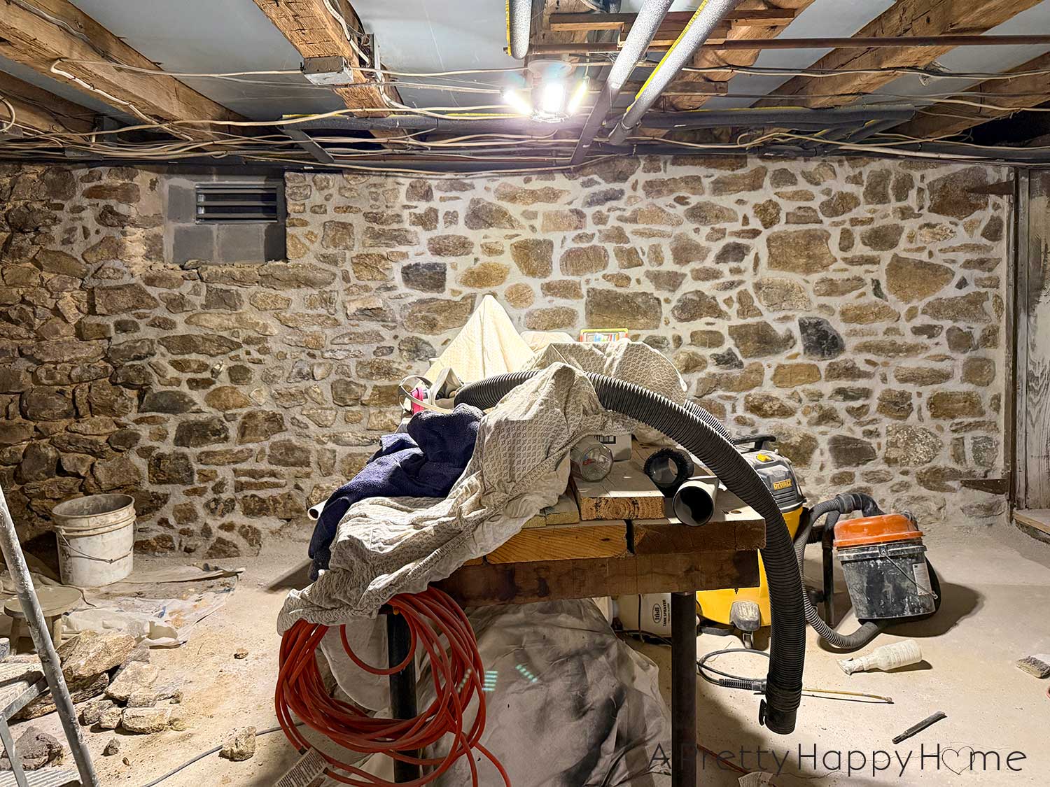 stone foundation wall in a basement in the process of being repointed with lime mortar using natural hydraulic lime