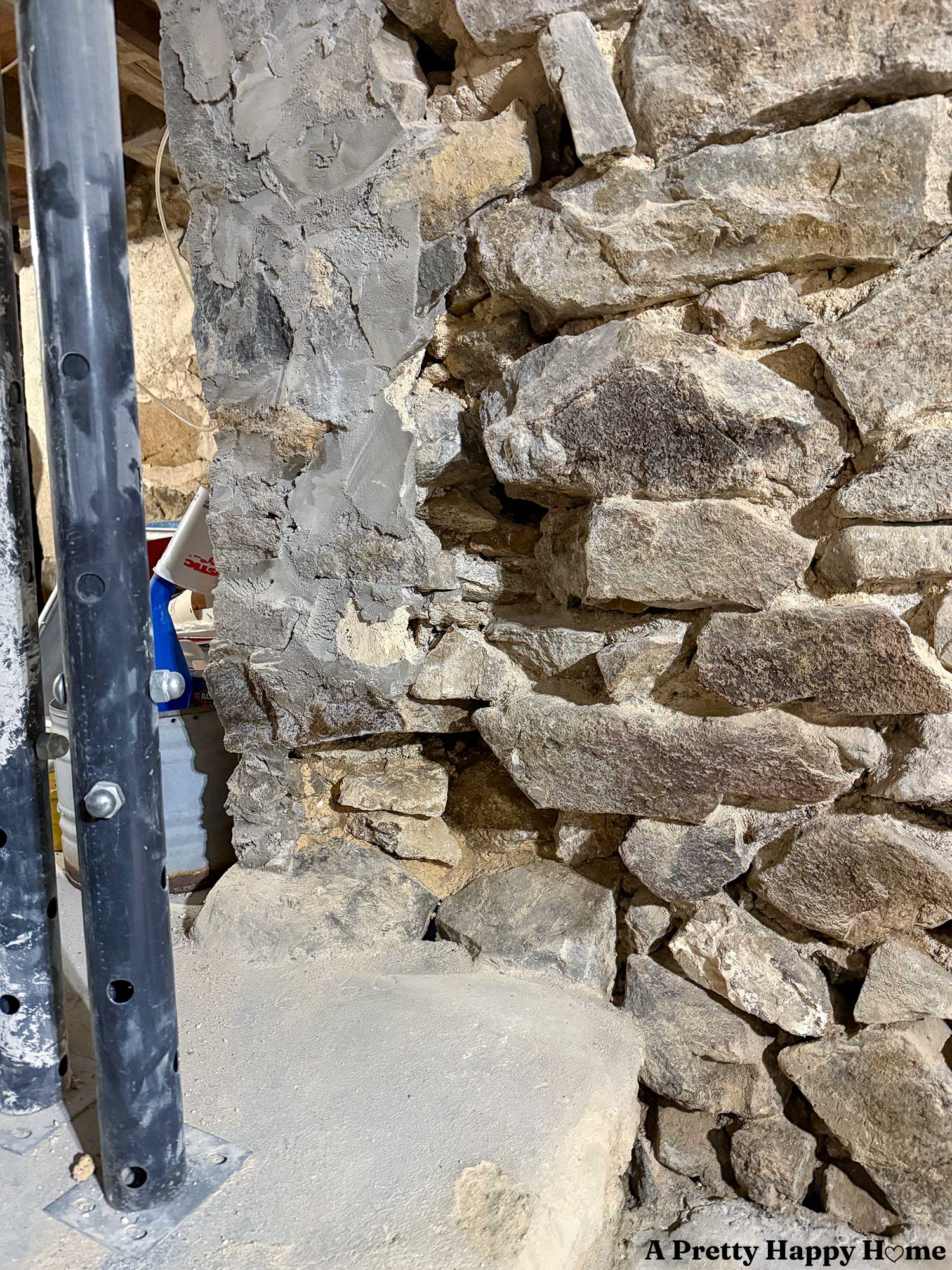 concrete on the stone foundation of a 1780s home that is hiding all sorts of problems like the fact that stones were removed to create a doorway
