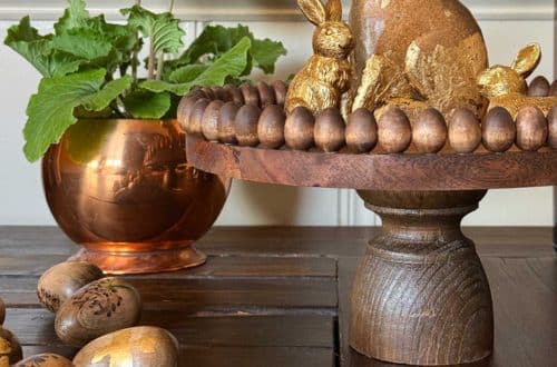 DIY wood pedestal or cake stand trimmed for Easter with mini wood eggs that are glued around the edge of the stand