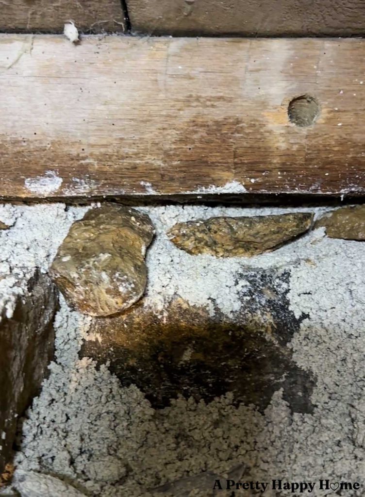 an interior stone foundation wall in the process of being repointed, the top of which is unstable and is being rebuilt