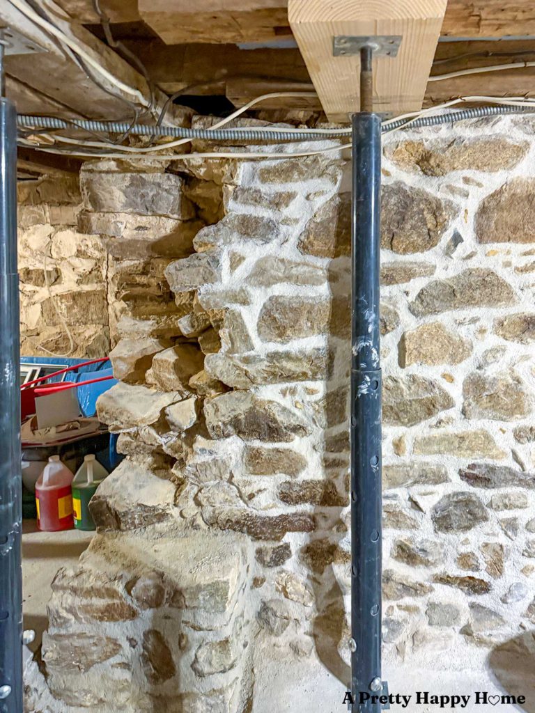 Rebuilding a stone foundation wall in a 1780s home to properly support a door header and floor joists