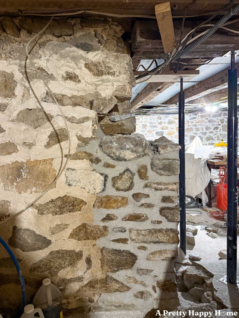 Rebuilding a stone foundation wall in a 1780s home to properly support a door header and floor joists