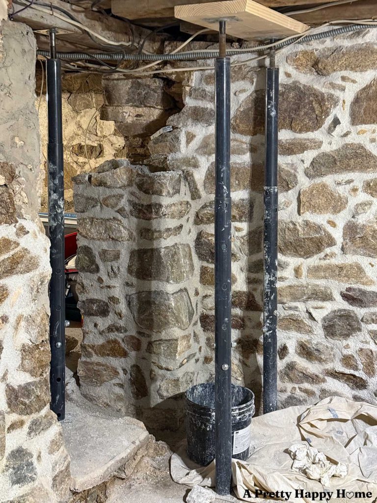 Rebuilding a stone foundation wall in a 1780s home to properly support a door header and floor joists